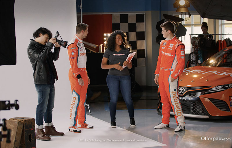 Two Nascar drivers talking to an Offerpad employee